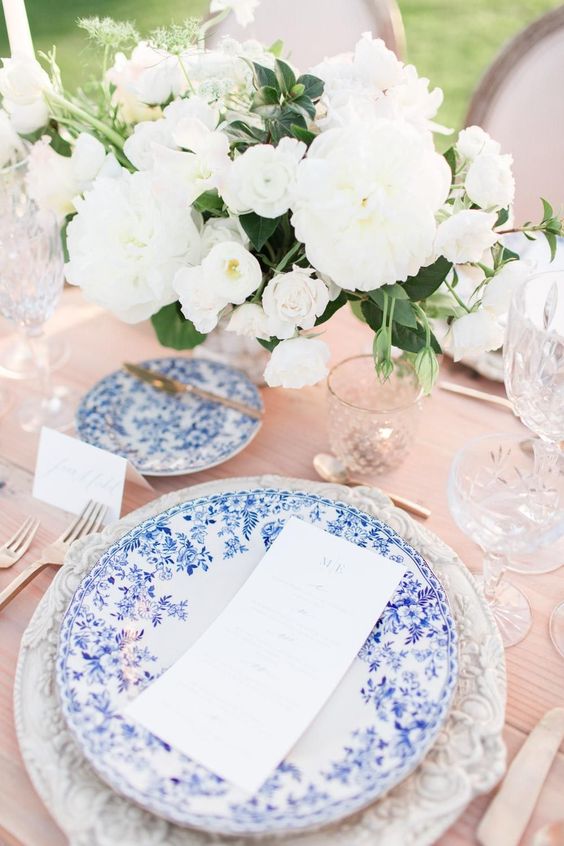 blue tablescape with chinoiserie plates and white and green flowers for blue green and white spring wedding 2021