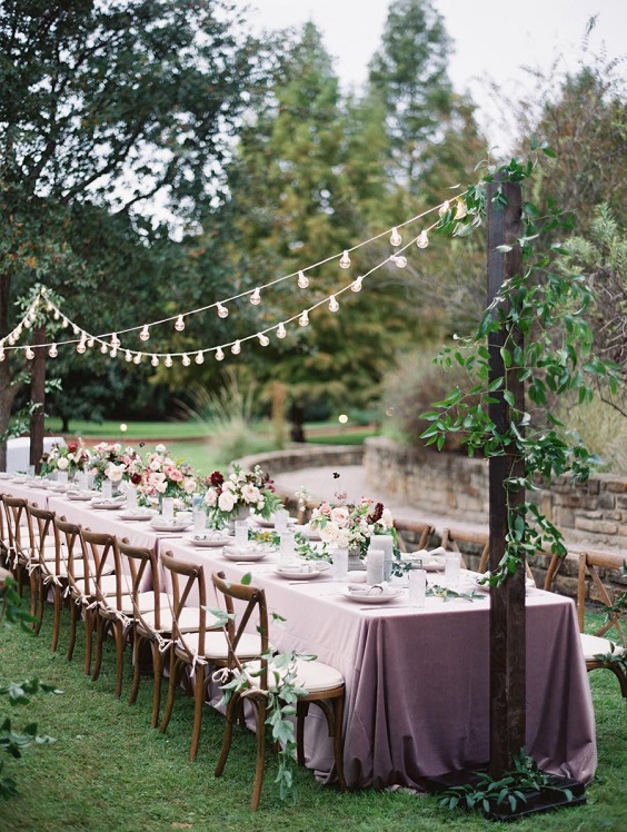 chairs and table with decorations for mauve and green summer wedding 2020