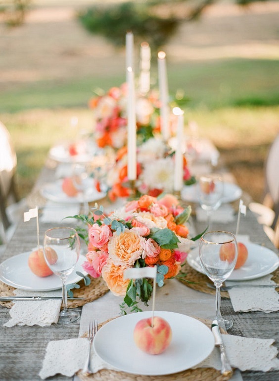 table setting and centerpieces for coral and peach summer wedding 2020