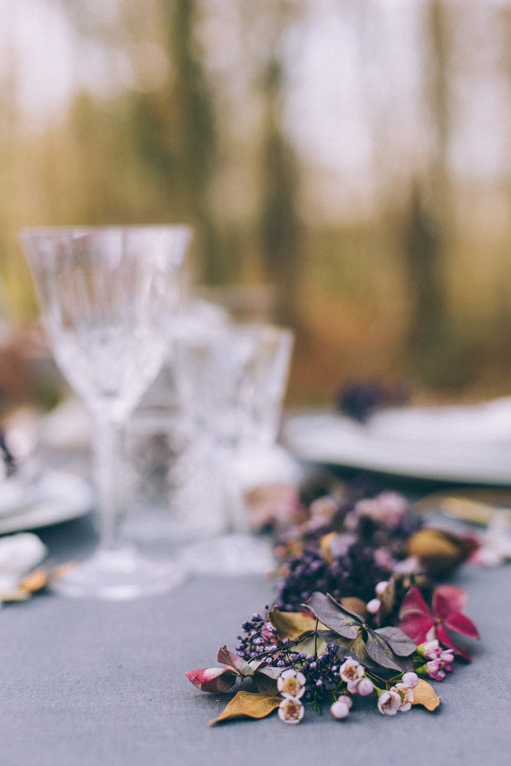 wine glasses and flower decorations for dusty blue and purple fall wedding 2020