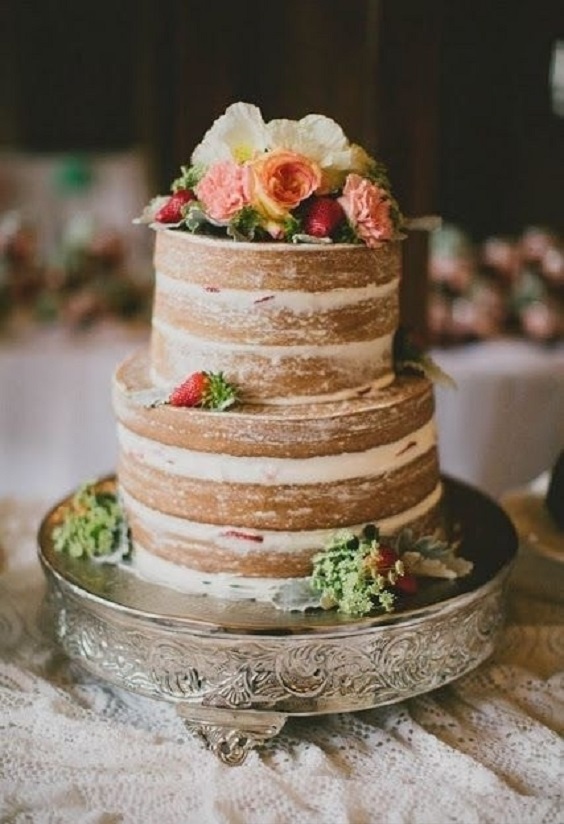naked wedding cake dotted with orange and green flowers for rust and yellow fall wedding 2020