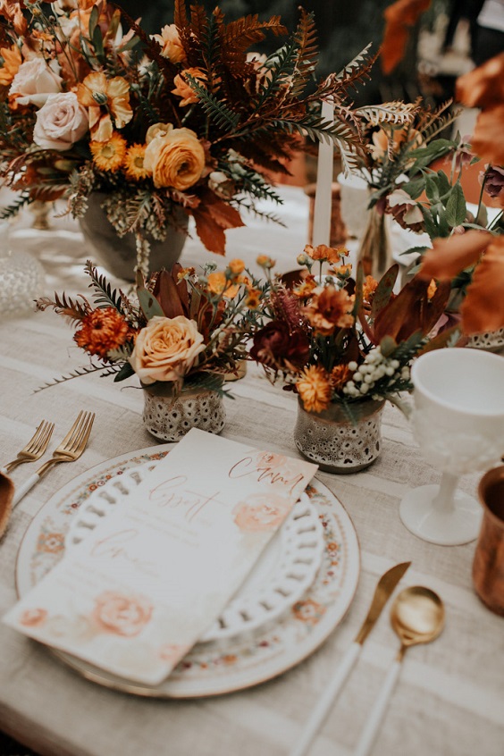 table setting and rust flower centerpieces for rust and yellow fall wedding 2020