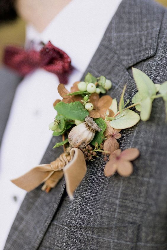 grey suit with burgundy bow tie and gold boutonniere for grey gold and burgundy fall wedding 2020