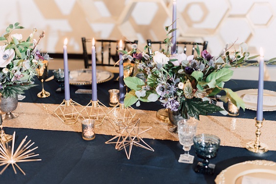 centerpices gilded candleholders and golden table runner for navy blue and gold december wedding 2020