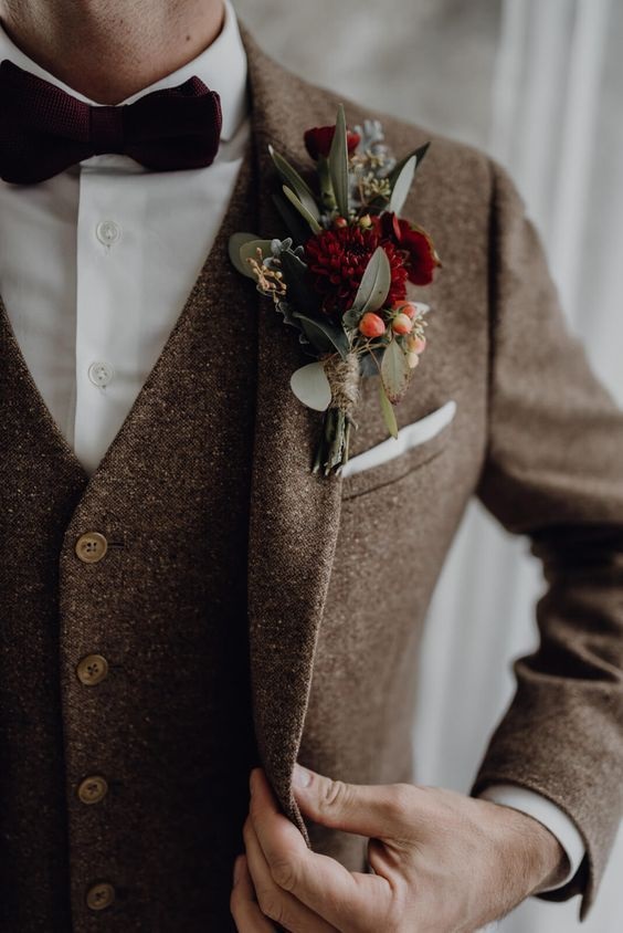 brown mens suit with burgundy boutonniere for burgundy and brown december wedding 2020