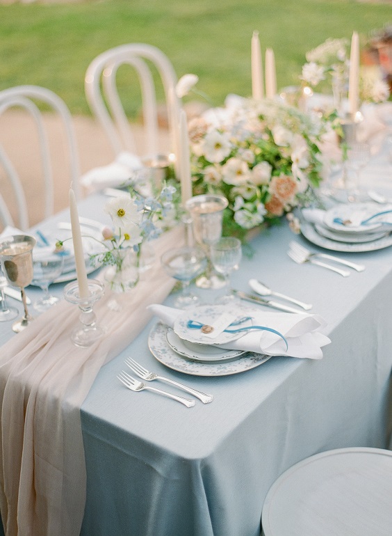 dusty blue table setting with table cloth for dusty blue and gray march wedding color 2021