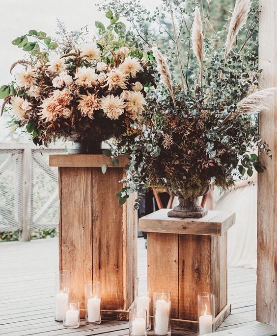 blush wedding flowers with greenery and white candles for blush and burgundy september wedding color 2020