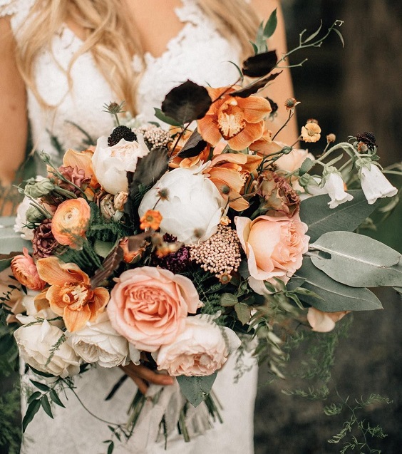 white bridesmaid dress and dusty orange bouquets for dusty orange and grey september wedding color 2020