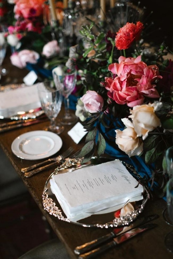 wedding table setting with flowers and greenery for navy blue and burgundy september wedding color 2020