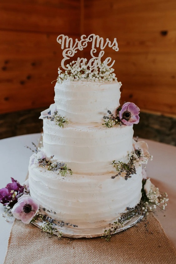 wedding cake with flowers for lavender and wood color rustic fall wedding