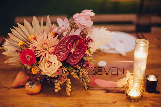 flower centerpiece for burgundy and orange rustic fall wedding
