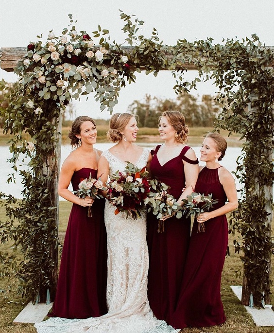 blush wedding dress with burgundy bridesmaids