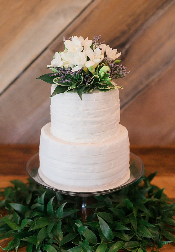 white wedding cake with lavender and greenery for navy lavender fall wedding colors