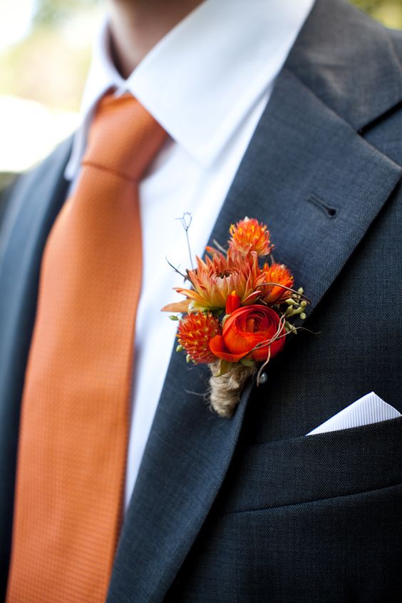 navy blue men suit with orange tie and boutonniere for navy orange fall wedding colors