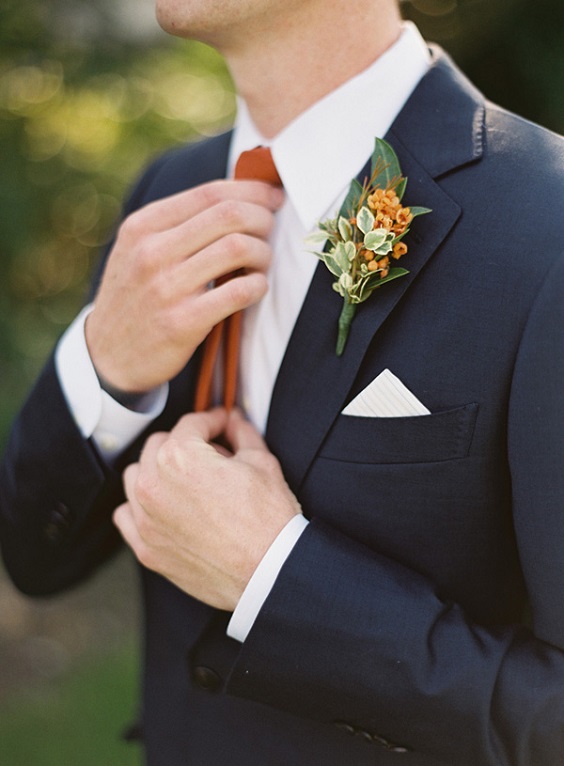 navy blue men suit with rust boutonniere for navy rust fall wedding colors