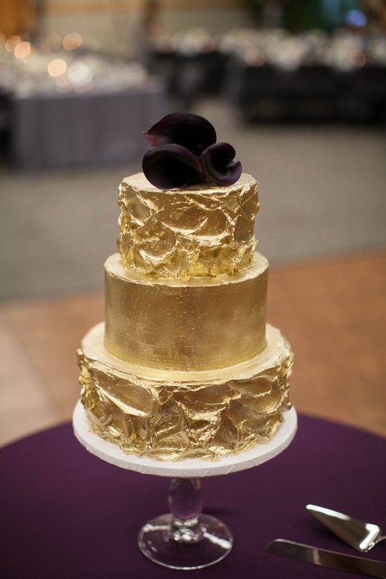 gold wedding cake on purple table cloth for purple and gold fall wedding colors