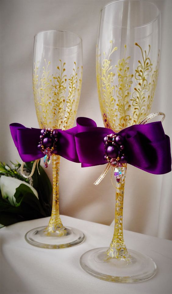 gold wine glasses with purple ribbon decoration for purple and gold purple fall wedding colors