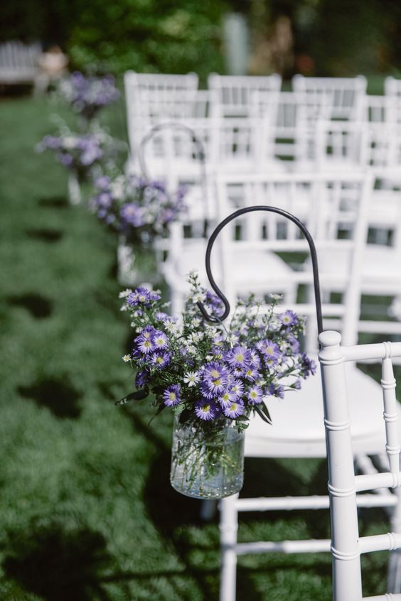 wedding chairs on green lawn for purple and greenery purple fall wedding colors