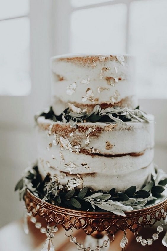 sage green and white wedding cake with glitter accents for neutral fall wedding colors sage green and gold