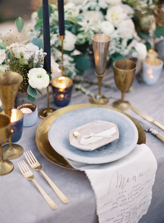 dusty blue tablecloth and gilded tableware for neutral fall wedding colors dusty blue and gold