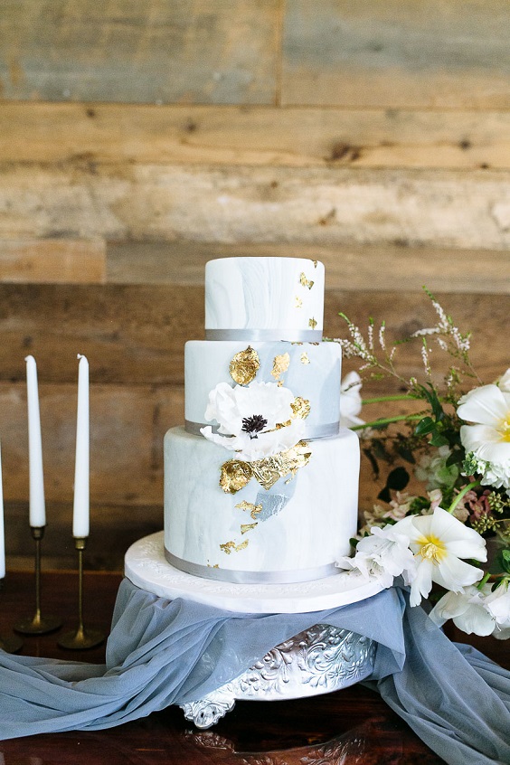 white wedding cake with dusty blue watercolors and glitter accents for neutral fall wedding colors dusty blue and gold