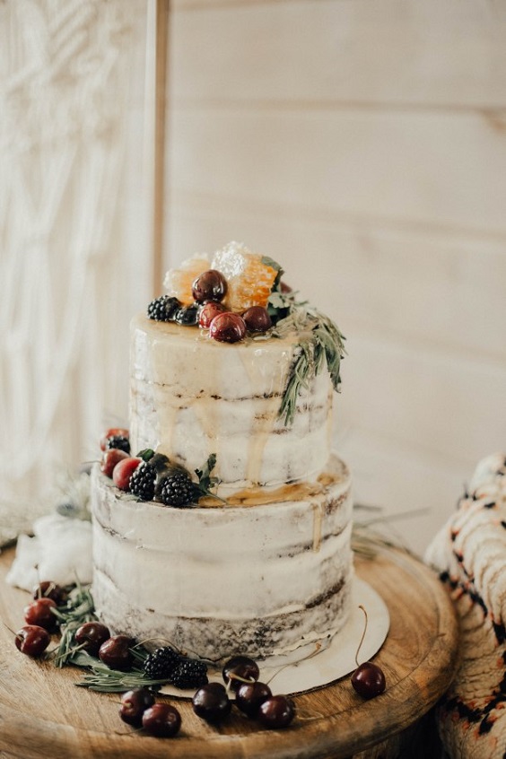 white wedding cake dotted with fruits for neutral fall wedding colors earth tones