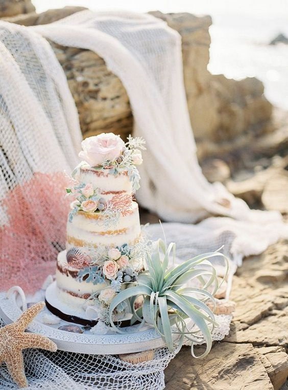 dusty blue wedding cake complement the seaside settings for dusty blue boho beach wedding