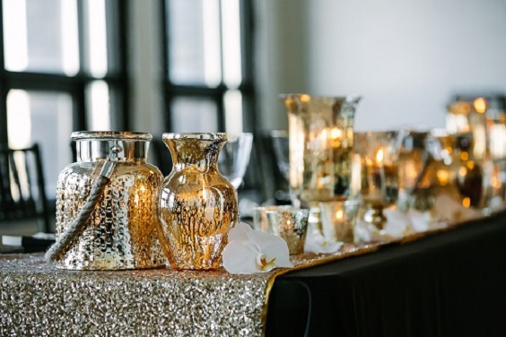 black wedding reception table with gold sequin table runner and mercury glass lanterns for black white gold wedding color