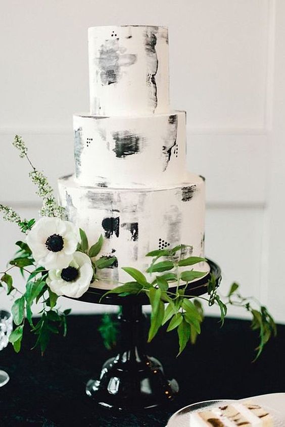 white and black wedding cake with flower and greenery for black wihte green wedding color