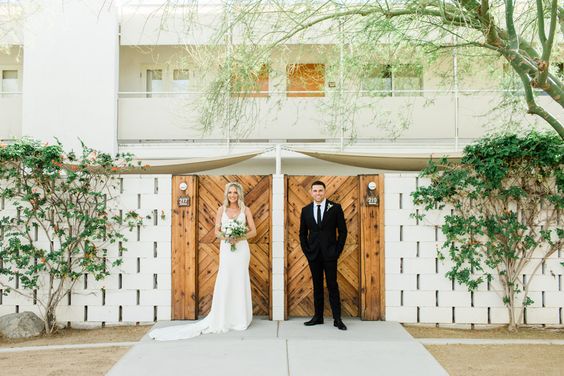 white bridal gown black groom suit in green trees backdrop for black white green wedding color