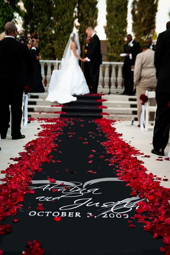 black aisle with red petals for red and black wedding colors red black and yellow