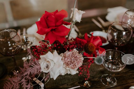 red pink and white centerpieces and wine glasses for red and black wedding colors red black and pink