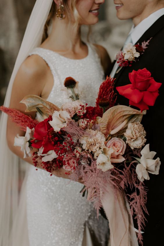 white bridal gown black mens suit and red and pink bouquet for red and black wedding colors red black and pink