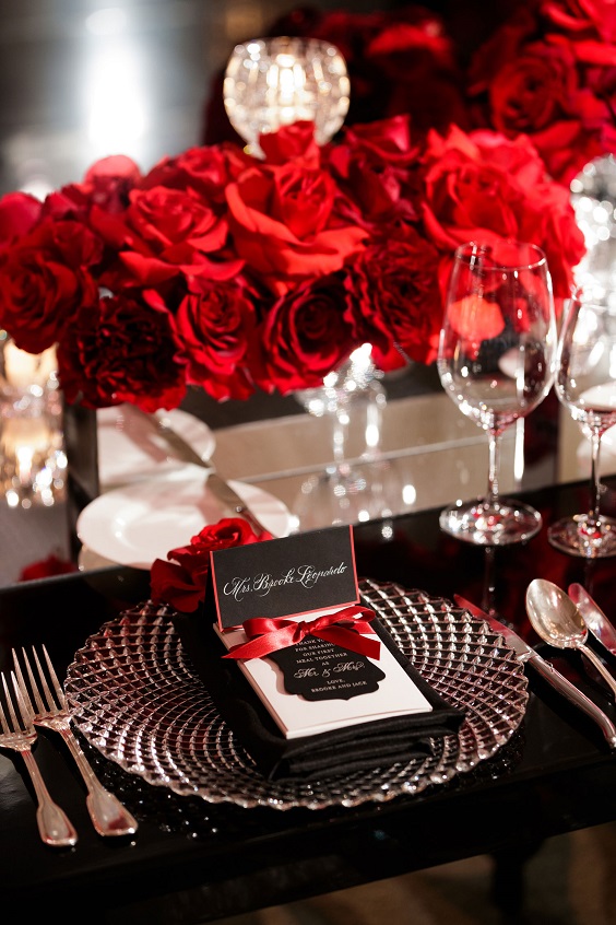 red flower centerpiece silver tableware and black napkin for red and black wedding colors red black and silver