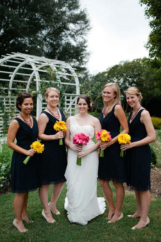 navy blue bridesmaid dresses and yellow pink bouquets