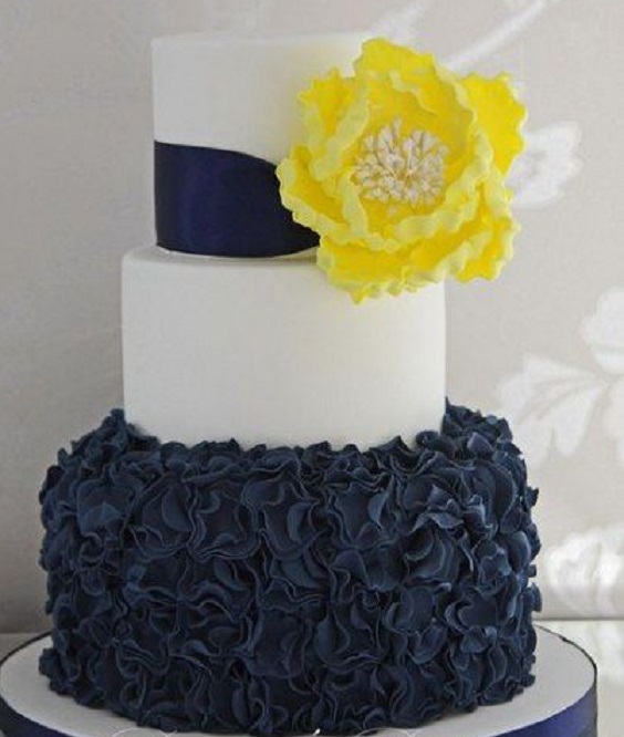 navy blue yellow wedding cake and cake topper