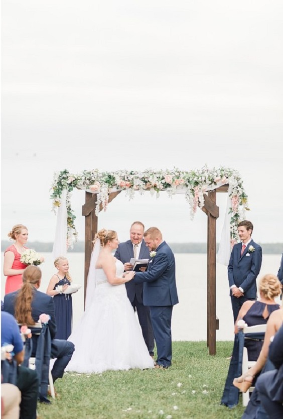 coral flower and greenery wedding arch for navy blue and coral wedding color beach
