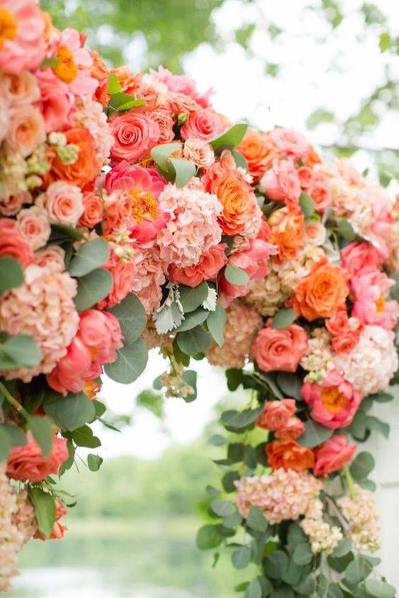 coral and peach flowers in wedding arch for navy blue and coral wedding color navy coral peach