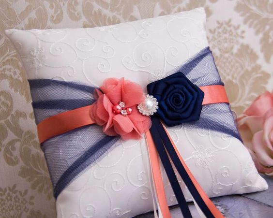 white wedding pillow with coral and navy ribbon amd flowers for navy blue and coral wedding color navy coral spring