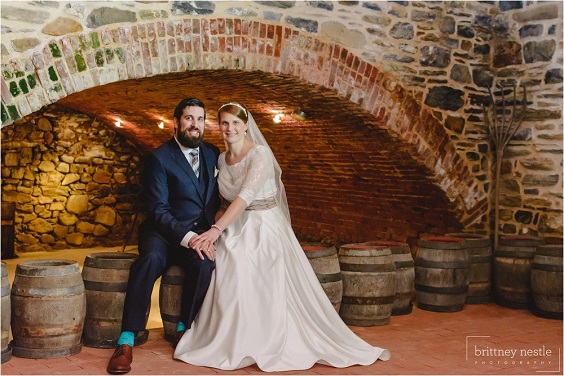 white bridal gown and mens suit for winter wedding in country barn