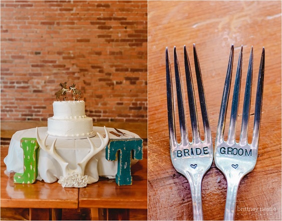 white wedding cake and forks for winter wedding in country barn