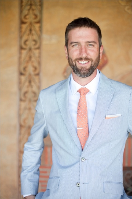 gray mens suit and coral tie for coral and gray wedding in country barn