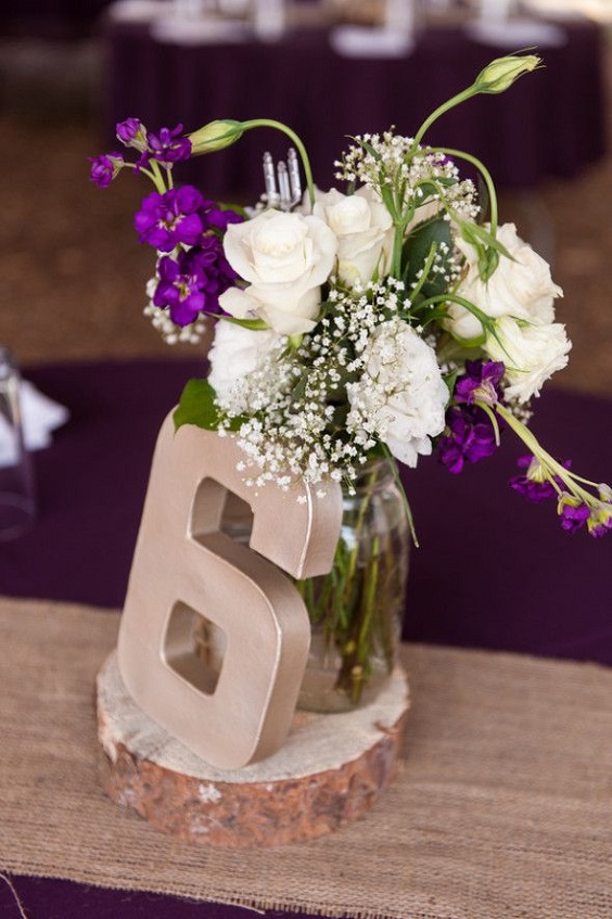 purple flowers and gold table number for purple and white wedding in country barn