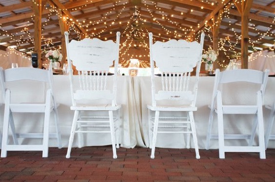 white wedding chairs for pink and green wedding in country barn