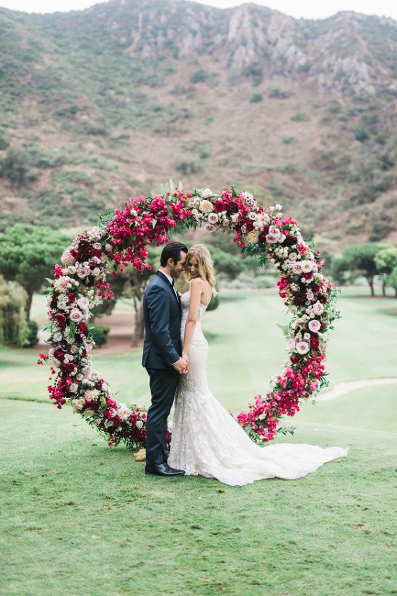 berry flowers and greenery arch for rustic outdoor wedding colors berry and dusty blue