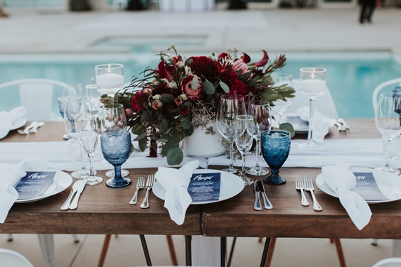 burgundy centerpieces and dusty blue glasses for rustic outdoor wedding colors dusty blue and burgundy