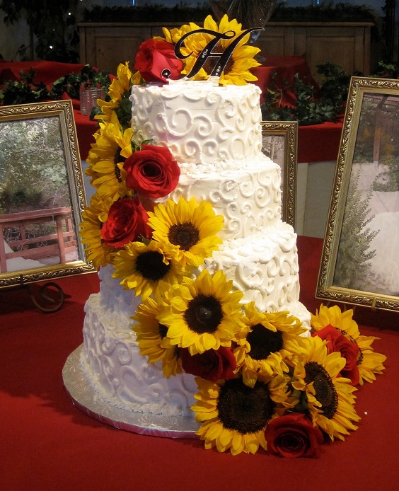 white wedding cake dotted with sunflower and red roses for sunflower and rose wedding sunflower and red rose