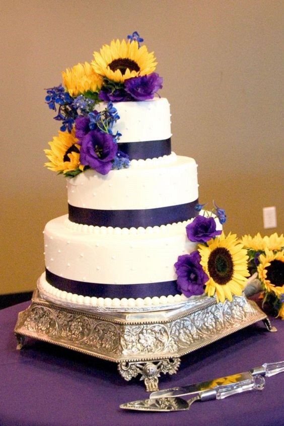 white wedding cake dotted with sunflower and purple roses for sunflower and rose wedding sunflower and purple rose