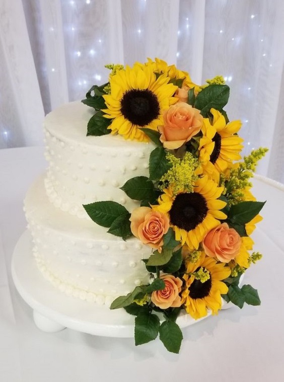 white wedding cake dotted with sunflower and peach roses for sunflower and rose wedding sunflower and peach rose