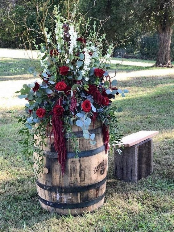 wedding aisle wine barrels with wine and teal flowers for wine and dark teal country chic wedding